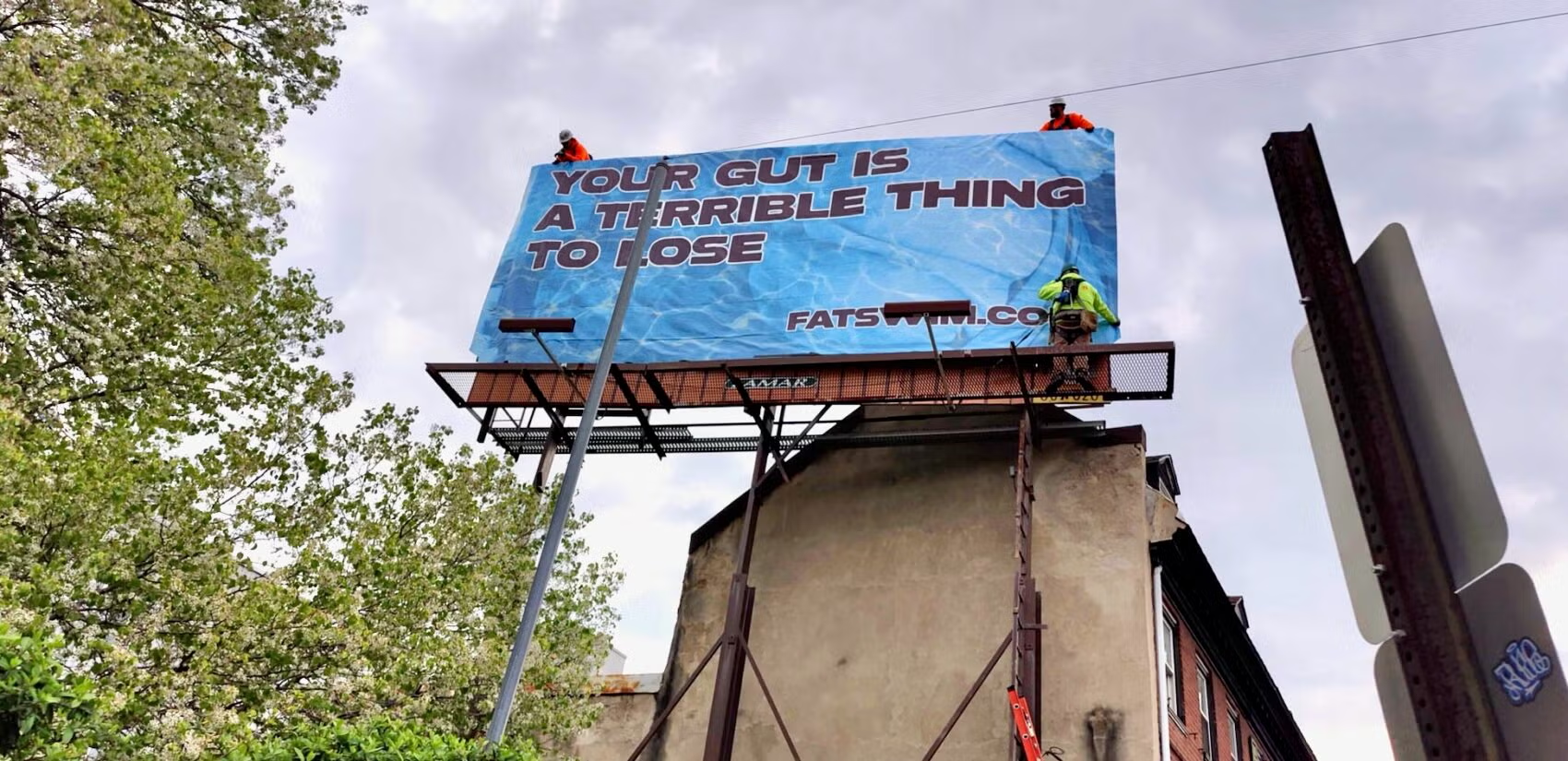 billboard with the text, "your gut is a terrible thing to lose"